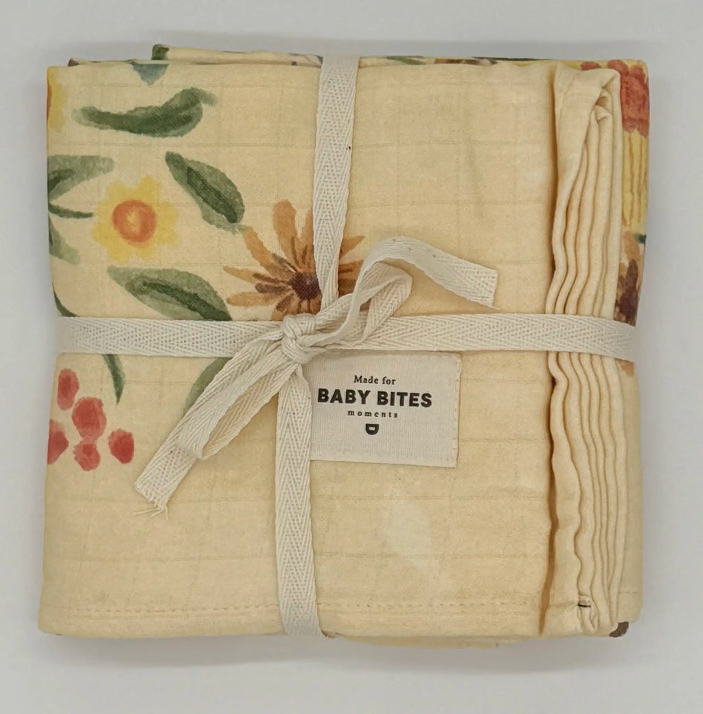 Baby Bites Honey Farm bamboo muslin swaddle blanket with bees, flowers and honeycomb folded